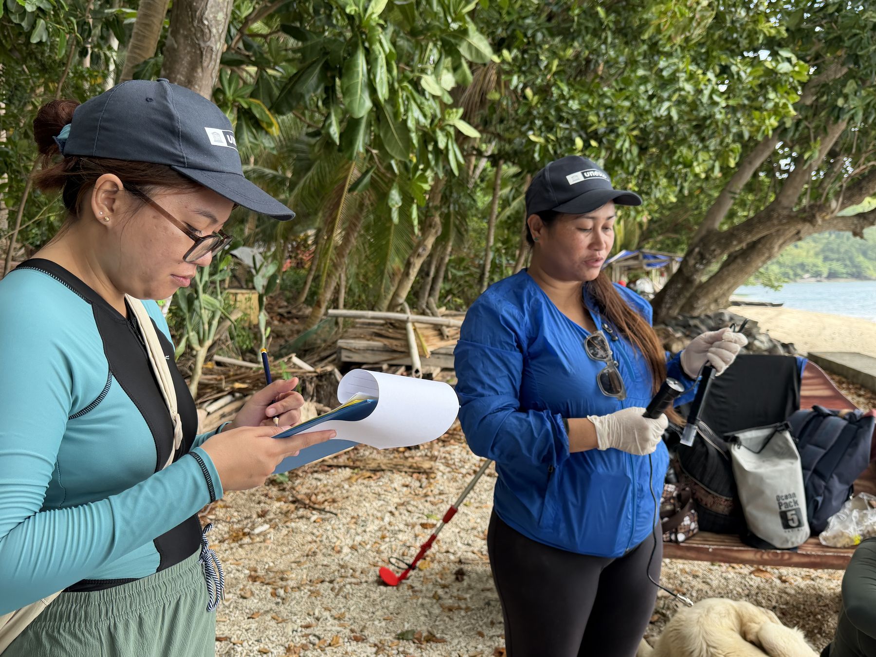 Sharon Rose Tabugo, the eDNA Expeditions site coordinator for the Philippines, is recording the temperature of a sample. Camiguin Island, Philippines, September 2026.