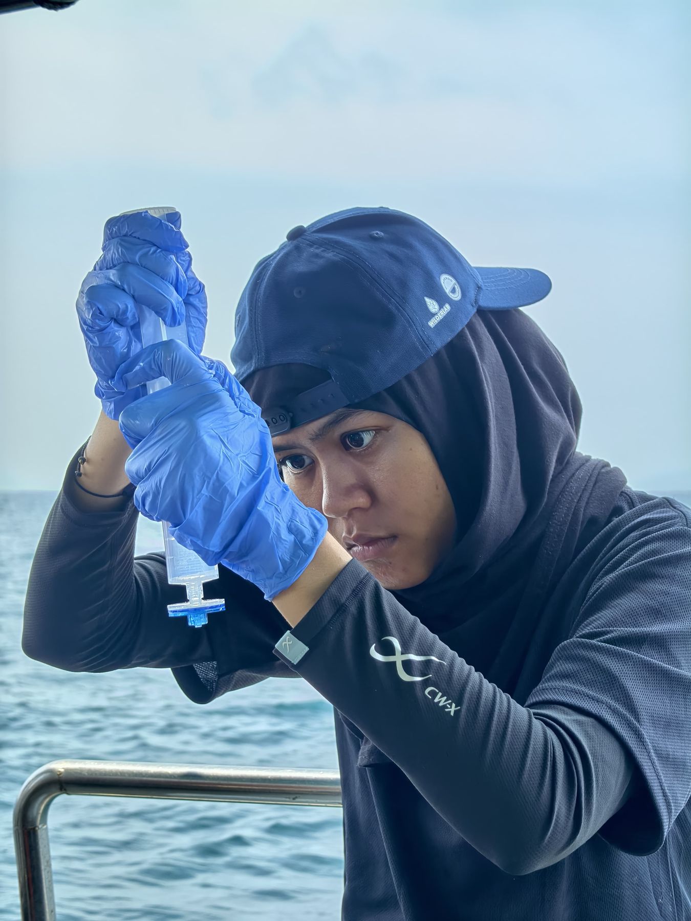 Filtering a water sample with a syringe. Terengganu, Malaysia, September 2026.