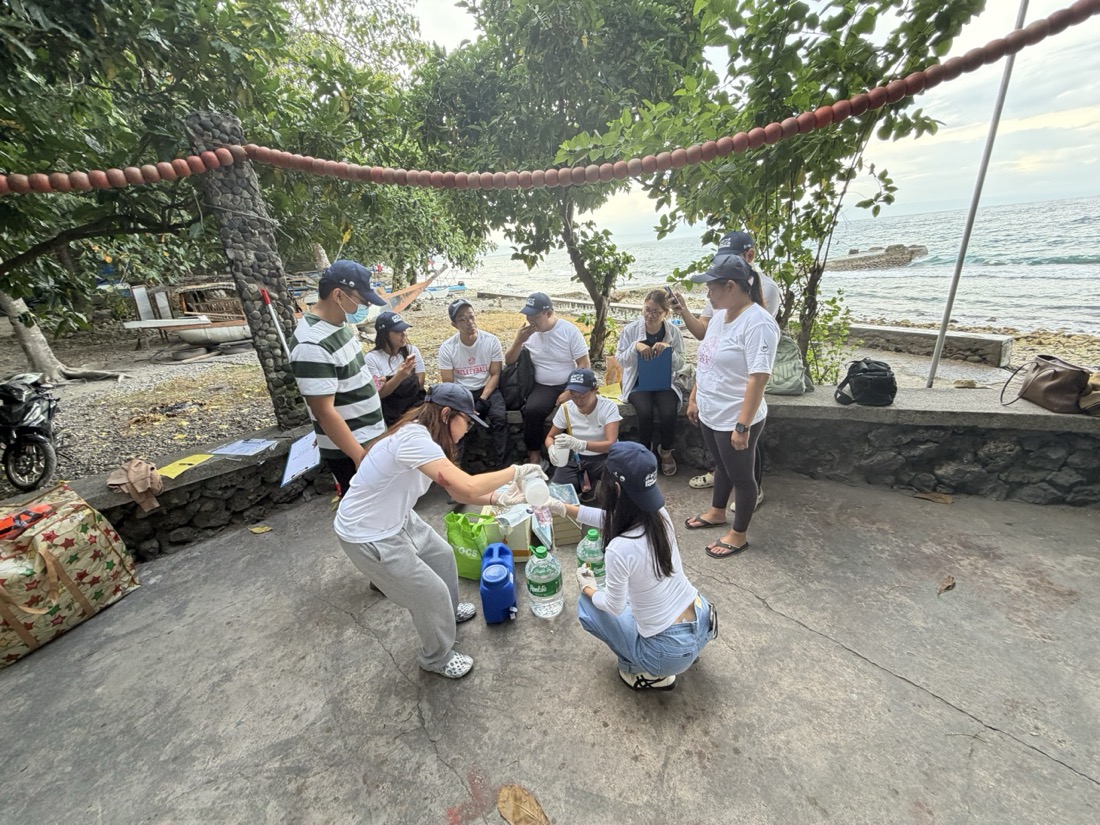 The team at Iligan Bay cleaning the sample bottles with clear water ahead of the sampling event, August 2026.