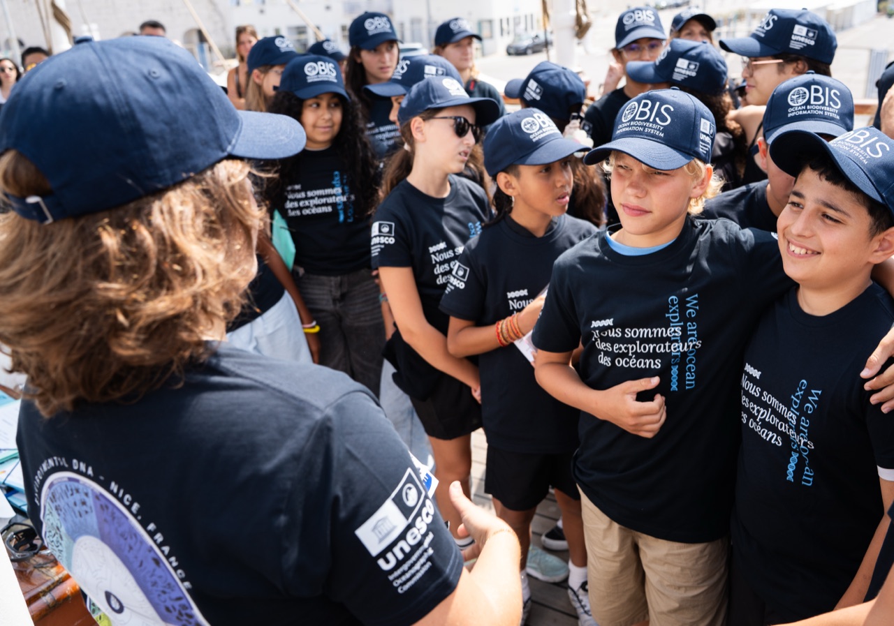 An IOC-UNESCO OBIS scientist briefing students on the deck of a tall ship